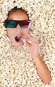 Little girl buried in popcorn