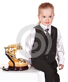 Little girl in business suit call telephone.