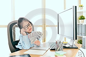 Little girl business worker looking at banknote