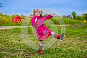 A little girl with butterfly net having fun