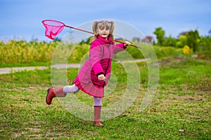 A little girl with butterfly net having fun