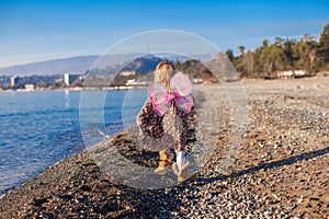 Little girl with butterfly wings running along the