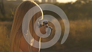 Little girl with camera at sunset