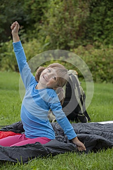 Little girl camping with sleeping bag