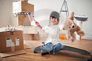 Little girl and cardboard boxes moving in a new home