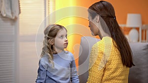 Little girl carefully listening to psychologist, kid crisis prevention childcare