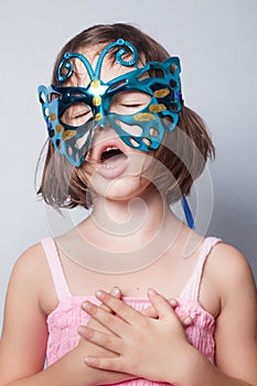 Little girl in carnival mask