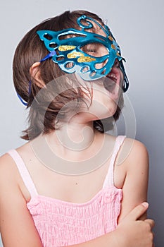 Little girl in carnival mask