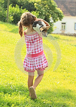 Little girl carrying a dog