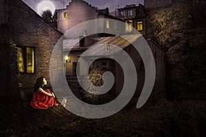 Little girl with a cat on the roof of the house