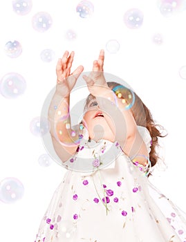 Little girl catches the bubbles