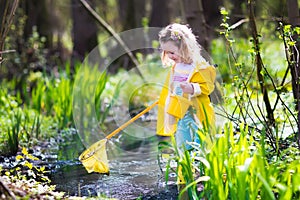 Little girl catching a frog