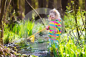 Little girl catching a frog