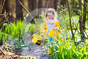 Little girl catching a frog