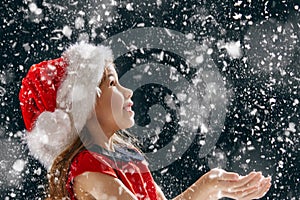 Little girl catching snowflakes