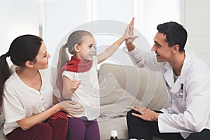 The little girl caught a cold. Her mother called the doctor at home. The girl gives the doctor high five