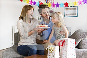 Little girl celebrating birthday party in modern white house.