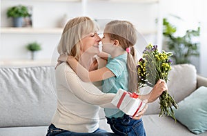 Little girl celebrating holiday, greeting her grandmother