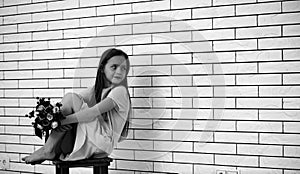 Little girl on a chair black and white