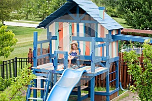 Little girl in chair on outdoor playset