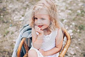 Little girl in a chair outdoors