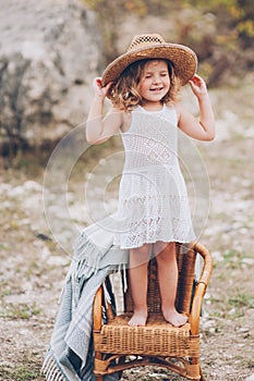 Little girl in a chair outdoors