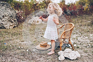 little girl in a chair outdoors