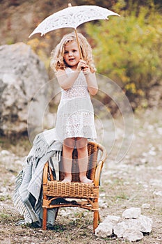 little girl in a chair outdoors