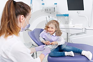 Little girl in chair visiting dentist