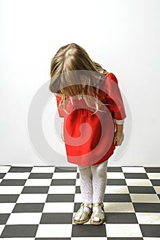 Little girl on checkered floor