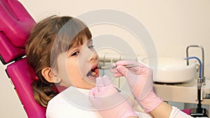 Little girl checks teeth