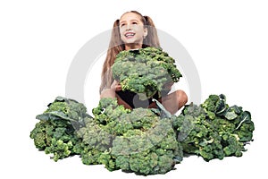 Little girl cheerfully holding head of broccoli and smiling