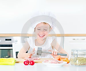 Little girl in chef hat.