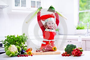 Little girl in chef hat preparing lunch