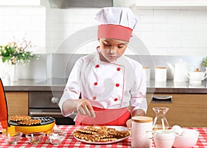 Little girl chef sprinkle with sugar baked waffles