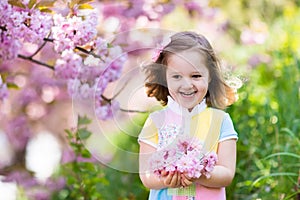 Little girl with cherry blossom