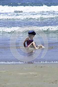 Little girl child enjoy the water of the sea