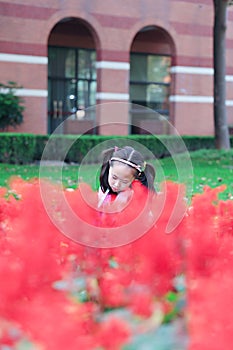 Little girl Child reading a book on the grass