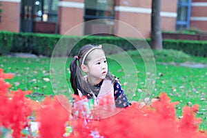 Little girl Child reading a book on the grass