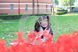 Little girl Child reading a book on the grass