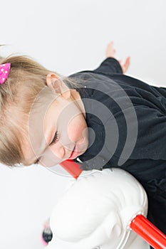 The little girl child riding Toy horse