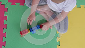 little girl child taking apart playing disassembling lego building blocks bricks