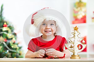 Little girl child wearing a festive red Santa hat