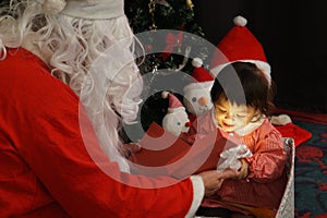 Little girl childhood cute happy smiling delighted with a gift box from Uncle Santa Claus