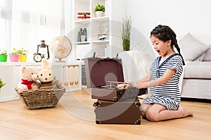 Little girl children opening vintage suitcase