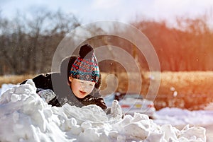 Little girl children play outdoors on snowy winter day