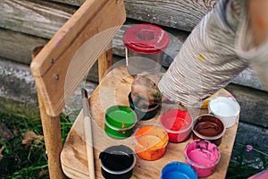 Little girl chooses a color to paint