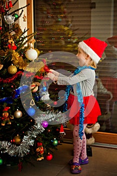 Little girl and christmas tree