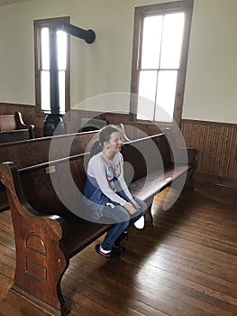 Little Girl in Church Pew