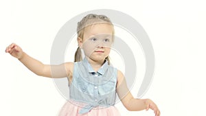 Little girl claps her hands in fun. White background. Slow motion